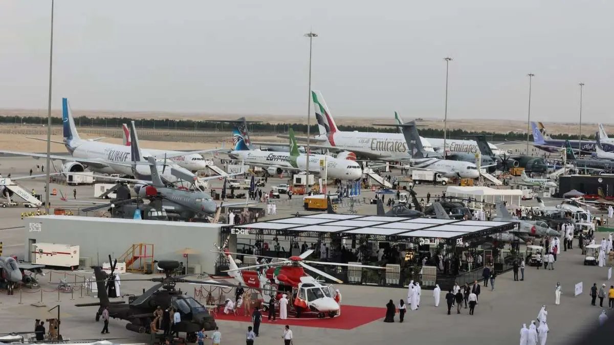Wide view of Dubai Airshow showing civil and military aircraft, exhibition stands and visiting delegations.